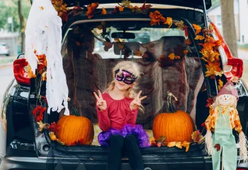 Girl in costume trunk or treating