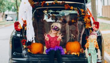 Girl in costume trunk or treating
