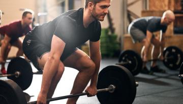 Group of men deadlifting
